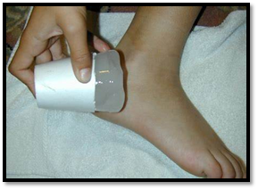 Closeup of an ice cup held against a foot